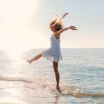 young-attractive-happy-woman-dancing-turning-around-by-sea-beach-sunny-summer-fashion-style_285396-7650