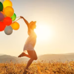 young-happy-woman-with-balloons-sunset-summer_772150-30